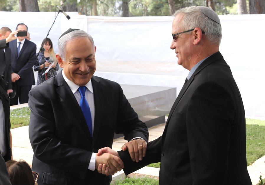 Prime Minister Benjamin Netanyahu shaking hands with Blue and White leader Benny Gantz at a memorial service honoring Shimon Peres Photo By: MARC ISRAEL SELLEM Likud, Blue & White coalition talks fail to make progress