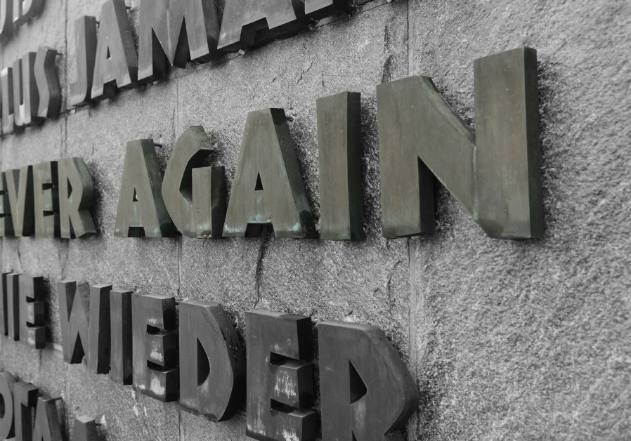 A sign at Dachau Concentration Camp reading "Never Again" Photo By: US AIR FORCE PHOTO ILLUSTRATION/SENIOR AIRMAN BRIANA JONES A sign at Dachau Concentration Camp reading "Never Again"