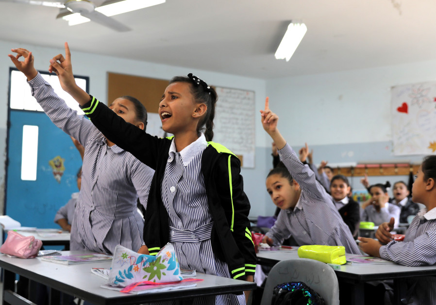 Palestinian schoolchildren take part in a lesson at a school run by UNRWA in the Shuafat refugee camp in East Jerusalem Photo By: AMMAR AWAD/REUTERS PA wipes peace agreements from schoolbooks, encourages incitement and intolerance