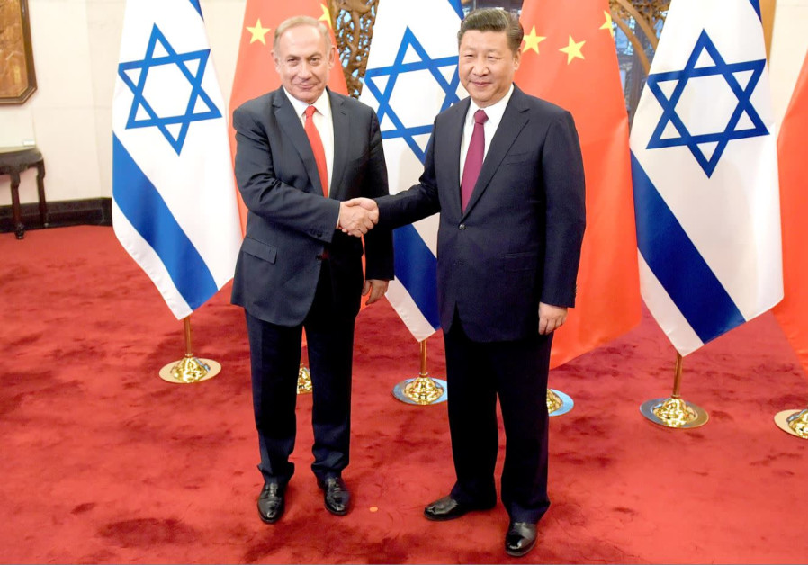 PRIME MINISTER Benjamin Netanyahu and Chinese President Xi Jinping shake hands ahead of their talks in China in March 2017 Photo By: ETIENNE OLIVEAU/POOL/REUTERS PRIME MINISTER Benjamin Netanyahu and Chinese President Xi Jinping shake hands ahead of their talks
