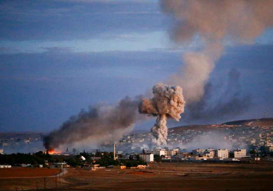 Smoke and flames rise over the Syrian border town of Kobani after an airstrike, October 20, 2014 Photo By: REUTERS kobani syria