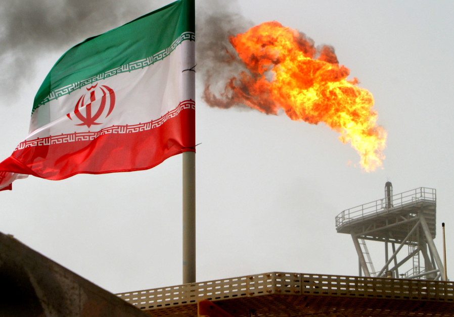 A gas flare on an oil production platform in the Soroush oil fields is seen alongside an Iranian flag in the Persian Gulf, Iran, July 25, 2005 Photo By: RAHEB HOMAVANDI/REUTERS Iran holding IAEA inspector was 'outrageous provocation'