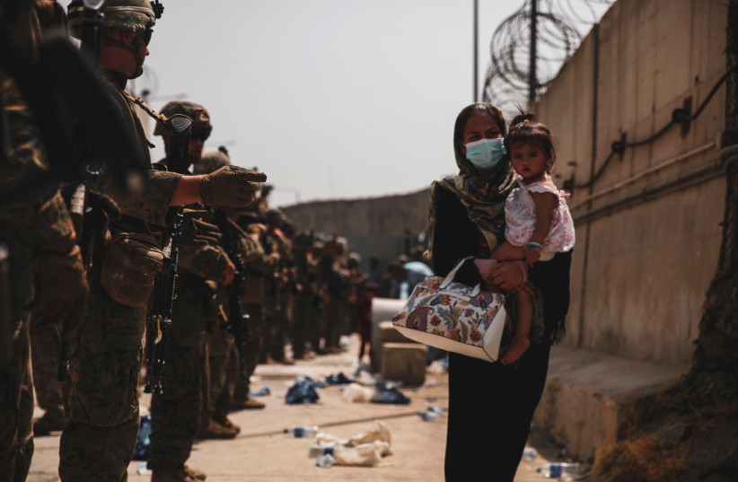 Marines with the 24th Expeditionary Unit (MEU) guide an evacuee during an evacuation at Hamid Karzai International Airport, Kabul, Afghanistan, in this photo taken on August 18, 2021 (credit: US NAVY/CENTRAL COMMAND PUBLIC AFFAIRS/SGT. ISAIAH COMPBELL/HANDOUT VIA REUTERS) Marines with the 24th Expeditionary Unit (MEU) guide an evacuee during an evacuation at Hamid Karzai International Airport, Kabul, Afghanistan, in this photo taken on August 18, 2021 (credit: US NAVY/CENTRAL COMMAND PUBLIC AFFAIRS/SGT. ISAIAH COMPBELL/HANDOUT VIA REUTERS)