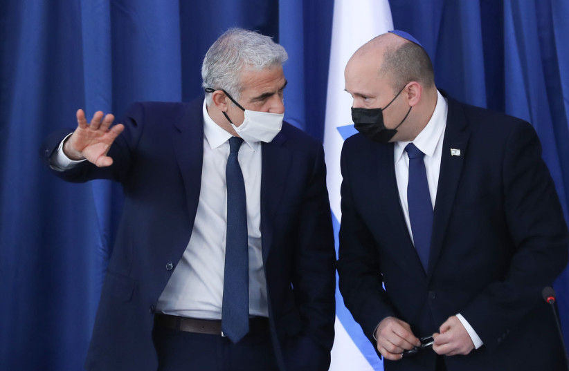 Israeli Prime Minister Naftali Bennett speaks with Foreign Minister Yair Lapid during a cabinet meeting at the Foreign Ministry in Jerusalem on August 8, 2021. (credit: OHAD TZVEIGENBERG/POOL) Israeli Prime Minister Naftali Bennett speaks with Foreign Minister Yair Lapid during a cabinet meeting at the Foreign Ministry in Jerusalem on August 8, 2021. (credit: OHAD TZVEIGENBERG/POOL)