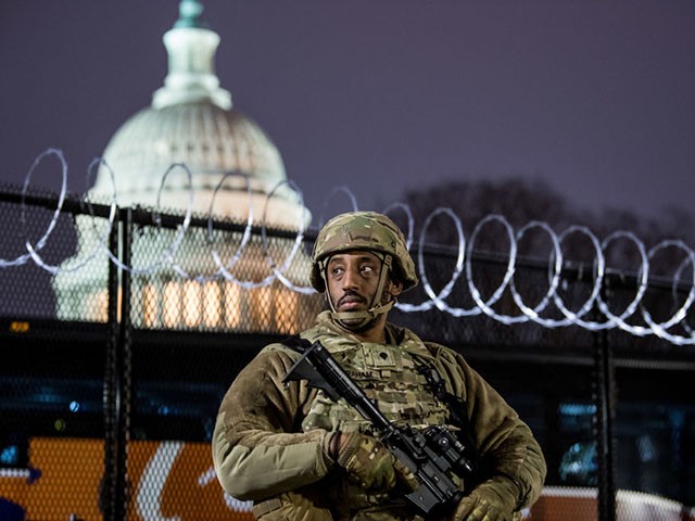 WASHINGTON, DC - JANUARY 15: VA National Guard stands outside the razor wire fencing that surrounds the US Capitol on January 15, 2021 in Washington, DC. After last week's Capitol Riot the FBI has warned of additional threats against the US Capitol and in all 50 states. According to reports, as many as 25,000 National Guard soldiers will be guarding the city as preparations are made for the inauguration of Joe Biden as the 46th U.S. President. (Photo by Liz Lynch/Getty Images)