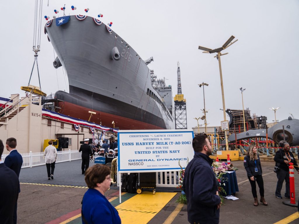 Guests walk past the USNS Harvey Milk at General Dynamics NASSCO shipyard during the ceremonial address in San Diego, California on November 6, 2021. - One of the first openly gay politicians in the United States, who was assassinated four decades ago, will have a ship named after him this weekend, as the US military looks to keep step with modern-day social attitudes. The USNS Harvey Milk honours a former navy diver who served at a time there was a ban on homosexuality in the armed forces, and who was later shot dead in San Francisco, months after winning public office. (Photo by ARIANA DREHSLER / AFP) (Photo by ARIANA DREHSLER/AFP via Getty Images)
