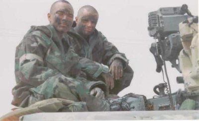 Sean Paul, left, and his gunner charcoaled their faces as Iraq launched scud missiles just after U.S. troops crossed the border. Troops used charcoal as a way to absorb any chemical agents as they donned their gas masks. Photo courtesy of the author.