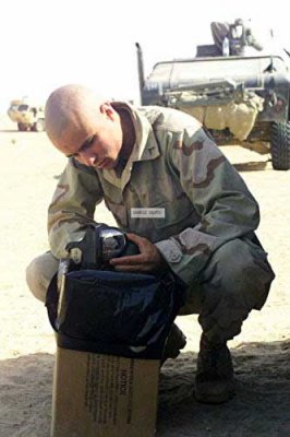 Sean Paul cleans a gas mask in Kuwait in 2003, just before U.S. forces invaded Iraq. Photo courtesy of the author.