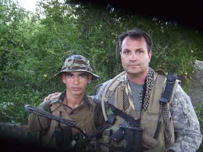 Nezamuddin Nezami, an Afghan commando, and Scott Mann pose after a combat patrol in southern Afghanistan in 2010. Mann, a retired Army lieutenant colonel, helped Nezami and his family escape Kabul last year after U.S. troops withdrew from the country. Photo courtesy of Scott Mann.