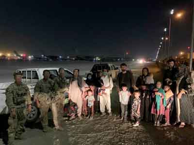 A group of Afghans wait at Hamid Karzai International Airport in Kabul during the U.S. withdrawal from Afghanistan last year. Task Force Pineapple aided their escape from the country. Photo courtesy of Scott Mann.