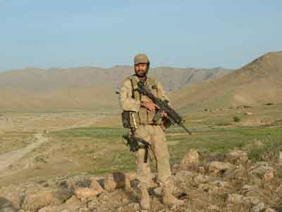 Scott Mann, a former Green Beret who trained Afghan special forces commandos during multiple tours in Afghanistan, stands in a valley in Oruzgan province in 2004. Photo courtesy of Scott Mann.