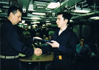 David Chetlain receives his “dolphins” from Capt. Larry Kraemer on the <em>USS Georgia</em> about halfway through his first patrol. Photo courtesy of the author.” width=”400″ height=”282″><noscript><img aria-describedby=