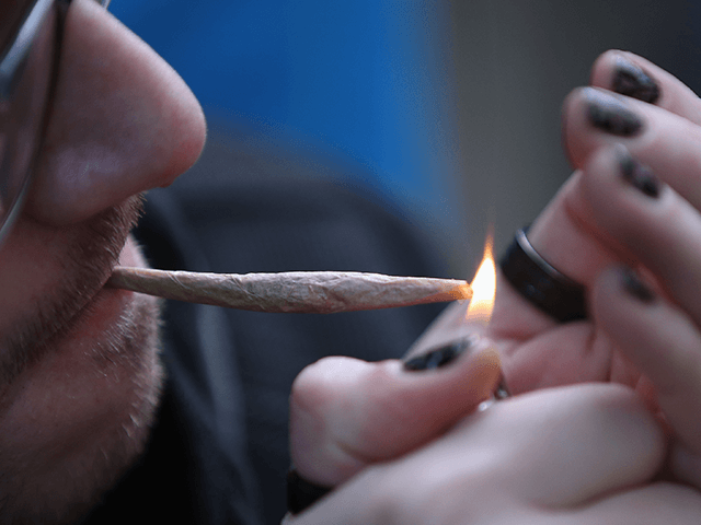A recreational marijuana smoker indulges in smoking weed on April 14, 2020 in the Bushwick section of the Brooklyn borough of New York City. As some smokers turn to smoking weed to ease their stress during the coronavirus pandemic, some doctors are warning that cannabis can cause airway inflammation that could cause complications should a user become a victim of COVID-19. (Photo by Bruce Bennett/Getty Images)