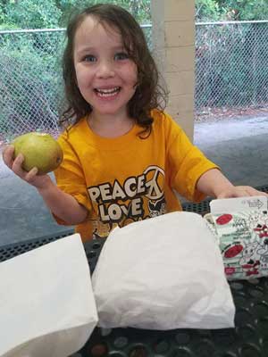 Magdylena Lopez, the daughter of an Army soldier stationed at Hunter Army Airfield, enjoys a free lunch from the Liberty County Summer Food Program on June 8, 2017, in Hinesville, Georgia. The program helps provide meals to kids free of charge as part of the county’s mission to alleviate food insecurity. Families are able to find a program site at many neighborhoods, parks, churches, and recreation centers throughout the county. Photo by Spc. Elizabeth Clark, courtesy of the U.S. Army.