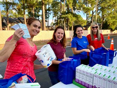Volunteers pose for a photo while packing bags with food to be distributed during the Military Family Advisory Network’s 1 million meal challenge at Manna Church, Oct. 23, 2021. Photo by Sgt. 1st Class Javier Orona, courtesy of the U.S. Army Reserves.