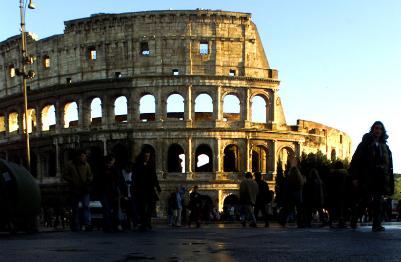A puddle reflects the Roman Colloseum following a rain shower in Rome. (credit: REUTERS) A puddle reflects the Roman Colloseum following a rain shower in Rome. (credit: REUTERS)