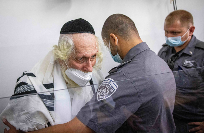 Rabbi Eliezer Berland covered with a prayer shawl arrives for a court hearing arrives for a police investigation at a police station in Jerusalem, November 2, 2021. (credit: YONATAN SINDEL/FLASH90) Rabbi Eliezer Berland covered with a prayer shawl arrives for a court hearing arrives for a police investigation at a police station in Jerusalem, November 2, 2021. (credit: YONATAN SINDEL/FLASH90)