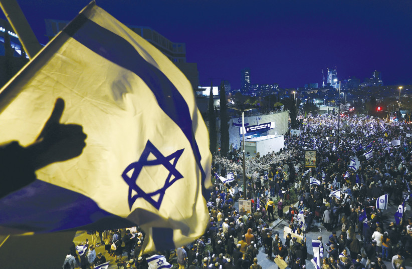 DEMONSTRATORS SUPPORTING the government’s plans for a judicial reform gather in Jerusalem on March 27 at the same time as anti-reform protesters, also carrying flags, rally elsewhere in the city. (credit: RONEN ZVULUN/REUTERS) DEMONSTRATORS SUPPORTING the government’s plans for a judicial reform gather in Jerusalem on March 27 at the same time as anti-reform protesters, also carrying flags, rally elsewhere in the city. (credit: RONEN ZVULUN/REUTERS)