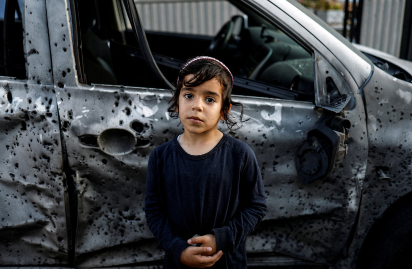 Five-year-old Lavi stands by a car that was damaged by a rocket, launched from Gaza, after it landed in Sderot, southern Israel, May 2, 2023. (credit: AMIR COHEN/REUTERS) Five-year-old Lavi stands by a car that was damaged by a rocket, launched from Gaza, after it landed in Sderot, southern Israel, May 2, 2023. (credit: AMIR COHEN/REUTERS)
