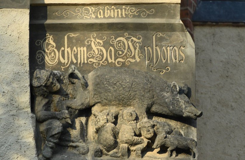 A thirteenth century anti-Semitic sculpture is displayed at St. Marien church in Wittenberg, Germany, January 24, 2020. A court is expected to rule on a motion seeking the removal of the 700-year-old sculpture known as “Judensau” or Jew pig. It is one of around 20 such relics from the Middle Ages th (credit: ANNEGRET HILSE / REUTERS) A thirteenth century anti-Semitic sculpture is displayed at St. Marien church in Wittenberg, Germany, January 24, 2020. A court is expected to rule on a motion seeking the removal of the 700-year-old sculpture known as “Judensau” or Jew pig. It is one of around 20 such relics from the Middle Ages th (credit: ANNEGRET HILSE / REUTERS)