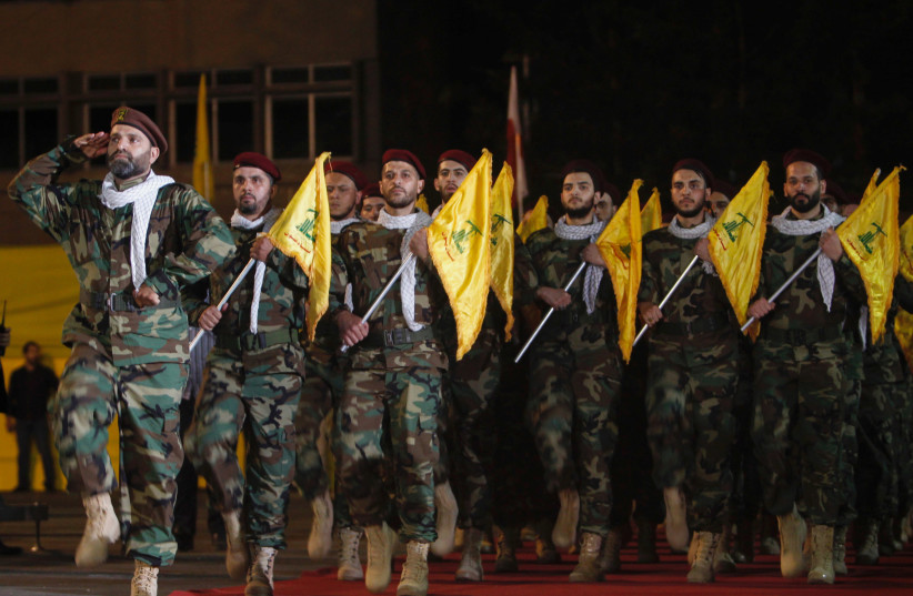 Members of Hezbollah march with party's flags during a rally marking al-Quds Day, (Jerusalem Day) in Beirut (credit: REUTERS) Members of Hezbollah march with party's flags during a rally marking al-Quds Day, (Jerusalem Day) in Beirut (credit: REUTERS)
