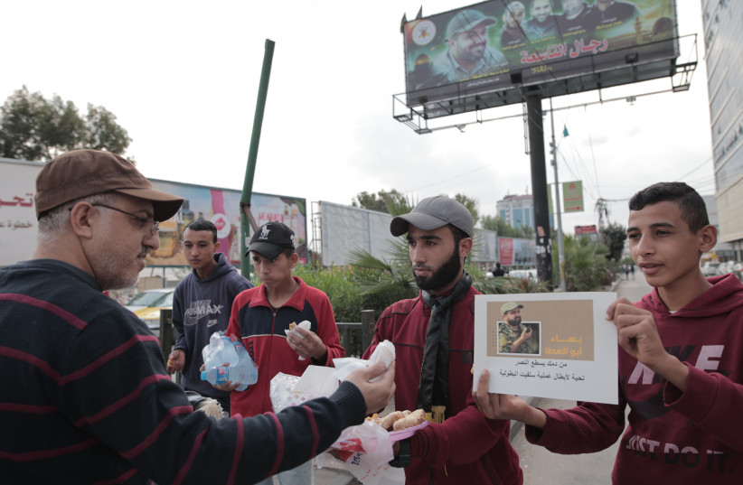 Palestinian supporters of the Islamic Jihad movement distribute sweets in celebration of the terror attack carried out by a Palestinian man earlier today in the West Bank, in Gaza City, on November 15, 2022. (credit: ATIA MOHAMMED/FLASH90) Palestinian supporters of the Islamic Jihad movement distribute sweets in celebration of the terror attack carried out by a Palestinian man earlier today in the West Bank, in Gaza City, on November 15, 2022. (credit: ATIA MOHAMMED/FLASH90)