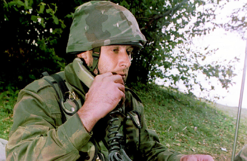 A Bosnian Serb soldier talks on a field-phone from a trench near the western Bosnian town of Kljuc October 4. Croatian radio reported armed conflict between Bosnian federal allies- Moslem and Croats in the area (credit: Ranko Cukovic/Reuters) A Bosnian Serb soldier talks on a field-phone from a trench near the western Bosnian town of Kljuc October 4. Croatian radio reported armed conflict between Bosnian federal allies- Moslem and Croats in the area (credit: Ranko Cukovic/Reuters)