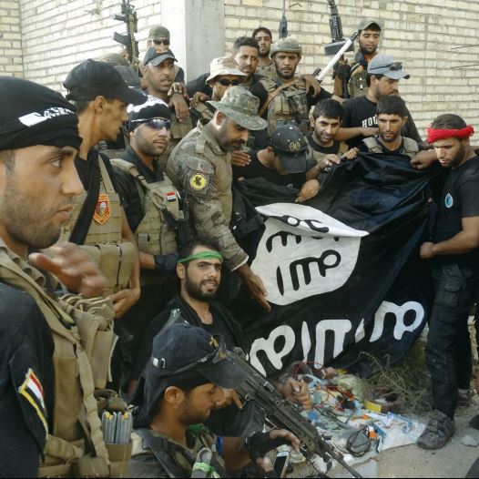 Iraqi security forces hold an Islamist State flag which they pulled down at the University of Anbar, in the western city of Ramadi on Sunday. (credit: REUTERS) Iraqi security forces hold an Islamist State flag which they pulled down at the University of Anbar, in the western city of Ramadi on Sunday. (credit: REUTERS)