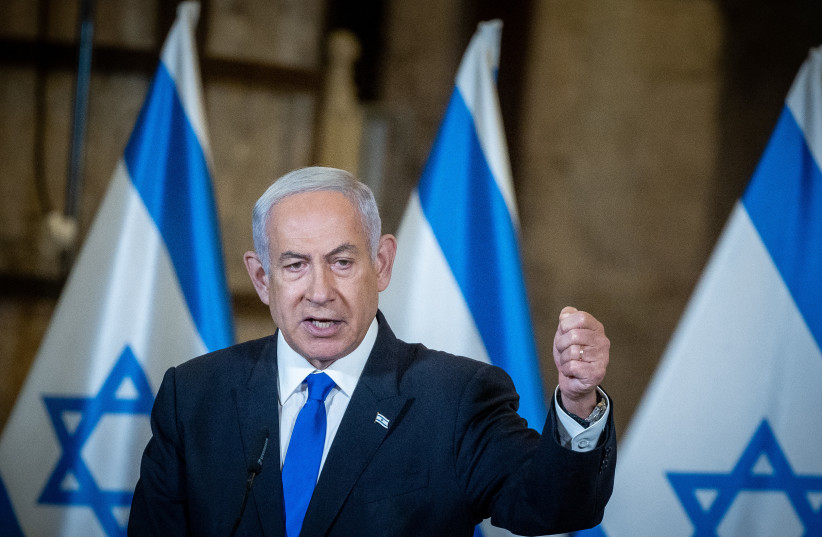 Israeli Prime Minister Benjamin Netanyahu, standing in front of Israeli flags, leads the weekly government conference, held at the Western Wall tunnels in Jerusalem's Old City on May 21, 2023. (credit: YONATAN SINDEL/FLASH90) Israeli Prime Minister Benjamin Netanyahu, standing in front of Israeli flags, leads the weekly government conference, held at the Western Wall tunnels in Jerusalem's Old City on May 21, 2023. (credit: YONATAN SINDEL/FLASH90)