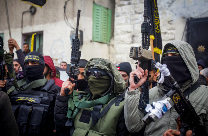 Palestinian gunmen and mourners attend the funeral of one of the two Palestinians who were killed by Israeli security forces after they opened fire on military post, in Jaba, near Jenin, in the West Bank, January 14, 2023 (credit: NASSER ISHTAYEH/FLASH90) Palestinian gunmen and mourners attend the funeral of one of the two Palestinians who were killed by Israeli security forces after they opened fire on military post, in Jaba, near Jenin, in the West Bank, January 14, 2023 (credit: NASSER ISHTAYEH/FLASH90)