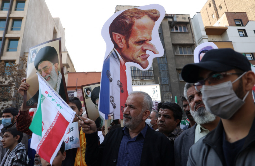 A demonstrator holds an image with a caricature of France President Emmanuel Macron during the 43rd anniversary of the US expulsion from Iran, in Tehran, Iran November 4, 2022 (credit: MAJID ASGARIPOUR/WANA (WEST ASIA NEWS AGENCY) VIA REUTERS) A demonstrator holds an image with a caricature of France President Emmanuel Macron during the 43rd anniversary of the US expulsion from Iran, in Tehran, Iran November 4, 2022 (credit: MAJID ASGARIPOUR/WANA (WEST ASIA NEWS AGENCY) VIA REUTERS)