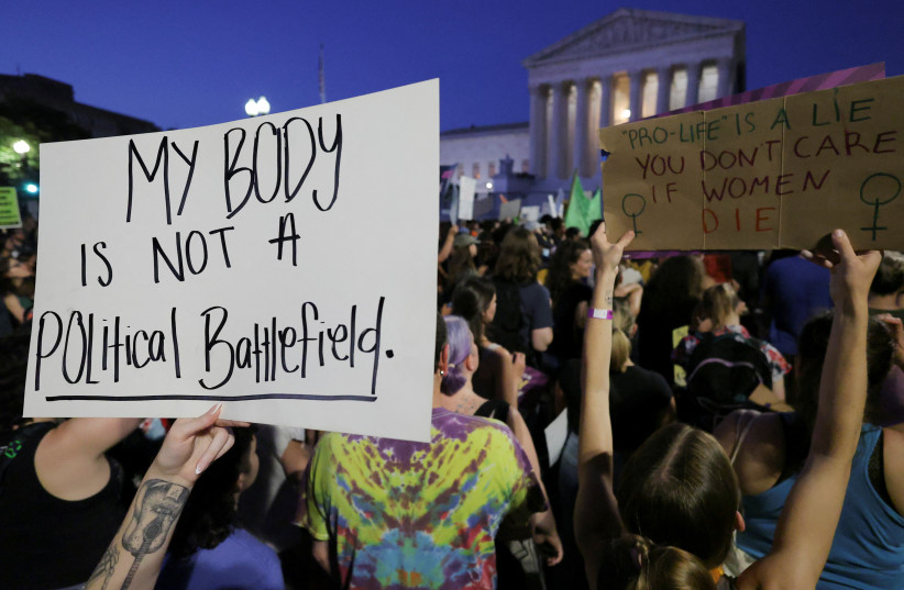 Abortion rights demonstrators protest outside the United States Supreme Court as the court rules in the Dobbs v Women's Health Organization abortion case, overturning the landmark Roe v Wade abortion decision in Washington, US, June 24, 2022. (credit: REUTERS/JIM BOURG) Abortion rights demonstrators protest outside the United States Supreme Court as the court rules in the Dobbs v Women's Health Organization abortion case, overturning the landmark Roe v Wade abortion decision in Washington, US, June 24, 2022. (credit: REUTERS/JIM BOURG)