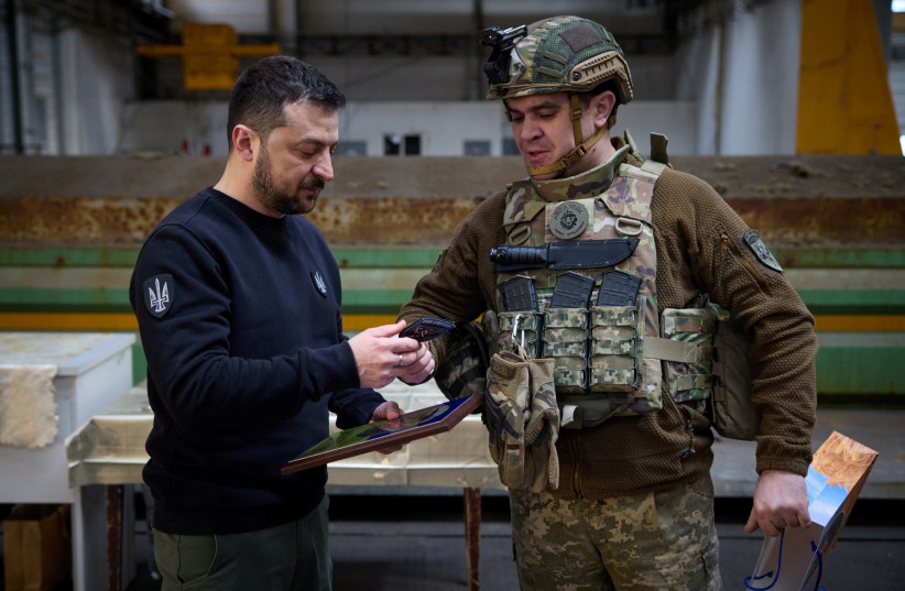 Ukraine's President Volodymyr Zelensky receives a military patch from a Ukrainian service member during his visit at a frontline, amid Russia's attack on Ukraine, in Avdiivka, Donetsk region, Ukraine April 18, 2023. (credit: Ukrainian Presidential Press Service/Handout via REUTERS) Ukraine's President Volodymyr Zelensky receives a military patch from a Ukrainian service member during his visit at a frontline, amid Russia's attack on Ukraine, in Avdiivka, Donetsk region, Ukraine April 18, 2023. (credit: Ukrainian Presidential Press Service/Handout via REUTERS)