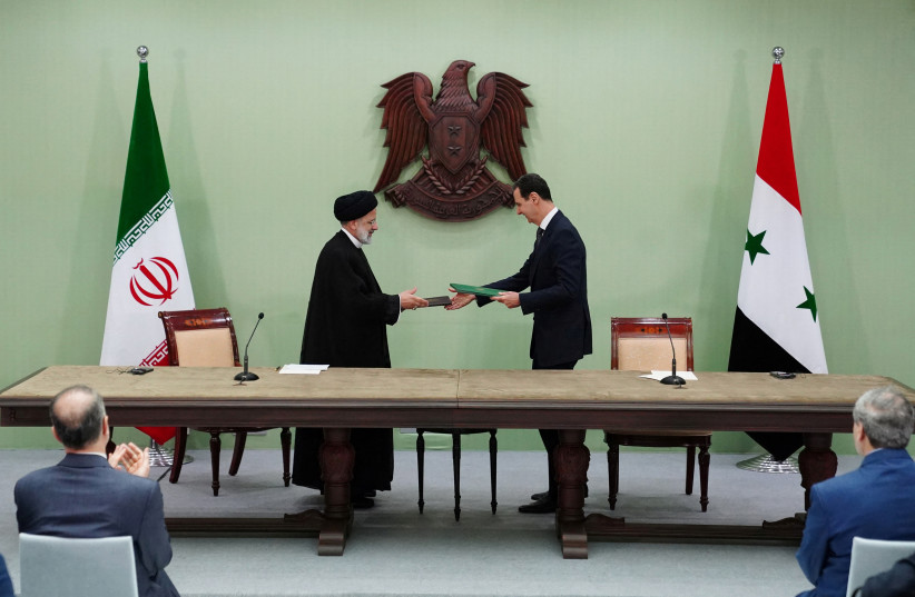 Syria's President Bashar al-Assad and Iranian President Ebrahim Raisi are pictured during the signing of cooperation agreement in Damascus, Syria, in this handout released by SANA on May 3, 2023 (credit: SANA/HANDOUT VIA REUTERS) Syria's President Bashar al-Assad and Iranian President Ebrahim Raisi are pictured during the signing of cooperation agreement in Damascus, Syria, in this handout released by SANA on May 3, 2023 (credit: SANA/HANDOUT VIA REUTERS)