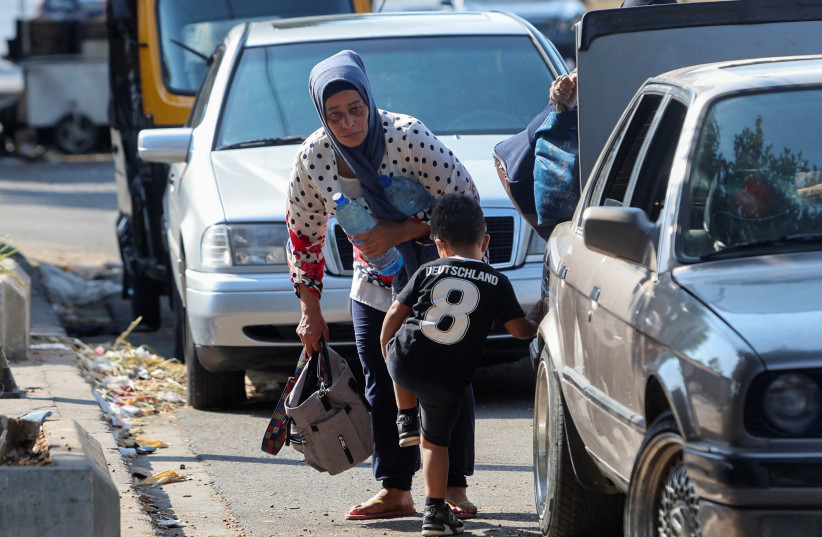 Residents who fled Ain el-Hilweh Palestinian refugee camp after Palestinian faction clashes carry their belongings, in Sidon, Lebanon July 30, 2023. (credit: REUTERS/AZIZ TAHER) Residents who fled Ain el-Hilweh Palestinian refugee camp after Palestinian faction clashes carry their belongings, in Sidon, Lebanon July 30, 2023. (credit: REUTERS/AZIZ TAHER)