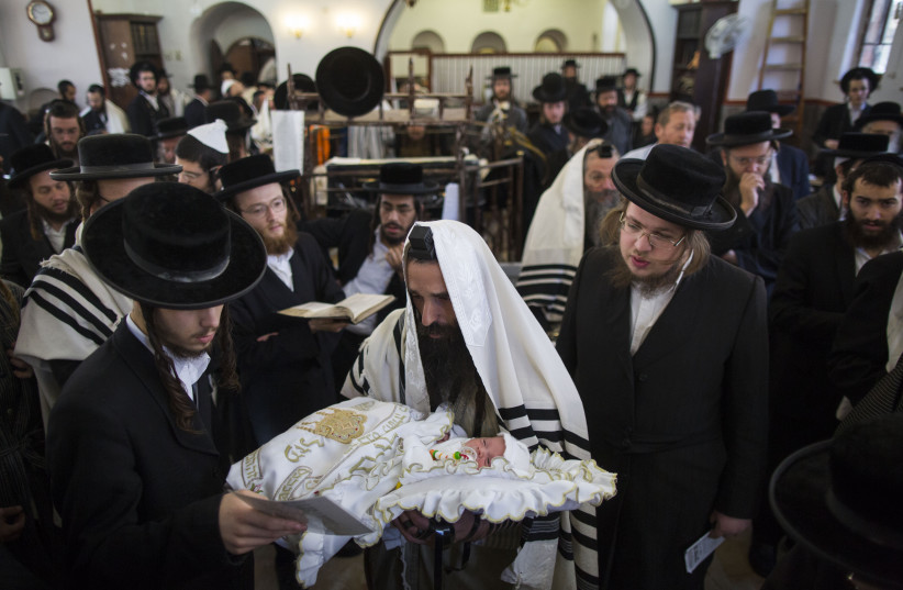 Haredi (ultra-Orthodox) Jews perform a brit mila in the ultra-orthodox neighborhood of Mea Shearim in Jerusalem on November 9, 2014 (credit: YONATAN SINDEL/FLASH90) Haredi (ultra-Orthodox) Jews perform a brit mila in the ultra-orthodox neighborhood of Mea Shearim in Jerusalem on November 9, 2014 (credit: YONATAN SINDEL/FLASH90)
