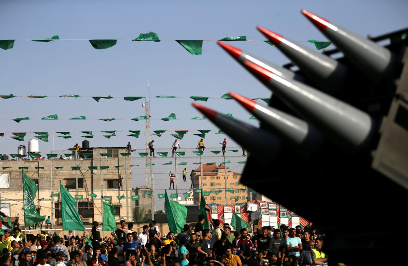 Palestinian Hamas supporters attend an anti-Israel rally as rockets are displayed on a truck by Hamas militants in Rafah, in the southern Gaza Strip May 28, 2021 (credit: REUTERS/IBRAHEEM ABU MUSTAFA) Palestinian Hamas supporters attend an anti-Israel rally as rockets are displayed on a truck by Hamas militants in Rafah, in the southern Gaza Strip May 28, 2021 (credit: REUTERS/IBRAHEEM ABU MUSTAFA)