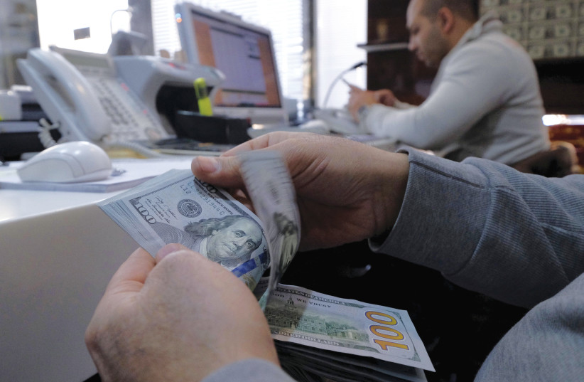 A MONEY changer counts out US dollars for a customer in Tehran’s business district. (credit: Raheb Homavandi/TIMA/Reuters) A MONEY changer counts out US dollars for a customer in Tehran’s business district. (credit: Raheb Homavandi/TIMA/Reuters)