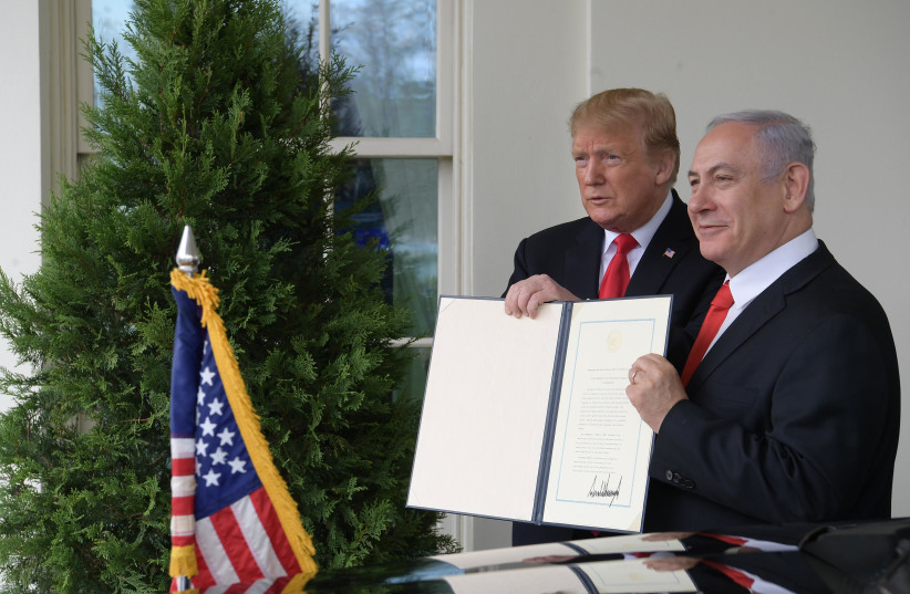 Prime Minister Benjamin Netanyahu and US President Donald Trump hold up the signed document acknowledging Israeli sovereignty over the Golan Heights, on March 25, 2019 (credit: AMOS BEN-GERSHOM/GPO) Prime Minister Benjamin Netanyahu and US President Donald Trump hold up the signed document acknowledging Israeli sovereignty over the Golan Heights, on March 25, 2019 (credit: AMOS BEN-GERSHOM/GPO)