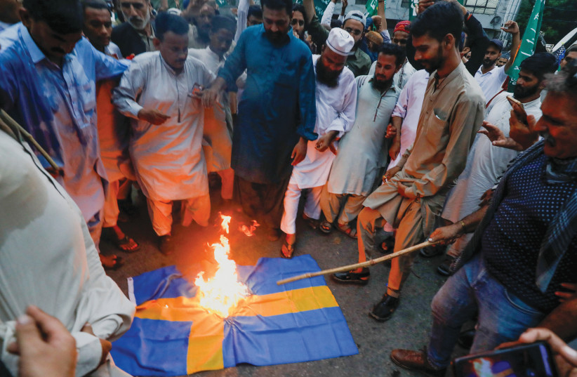 BURNING A Swedish flag to denounce the desecration of a Koran outside a Stockholm mosque, in Karachi, Pakistan, July 7. (credit: Akhtar Soomro/Reuters) BURNING A Swedish flag to denounce the desecration of a Koran outside a Stockholm mosque, in Karachi, Pakistan, July 7. (credit: Akhtar Soomro/Reuters)