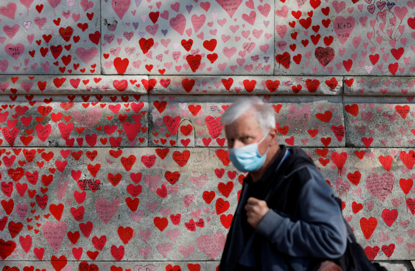 A man wearing a face-mask walks past The National Covid Memorial Wall, on national day of reflection to mark the two year anniversary of the UK going into national lockdown, in London (credit: REUTERS/PETER CZIBORRA) A man wearing a face-mask walks past The National Covid Memorial Wall, on national day of reflection to mark the two year anniversary of the UK going into national lockdown, in London (credit: REUTERS/PETER CZIBORRA)