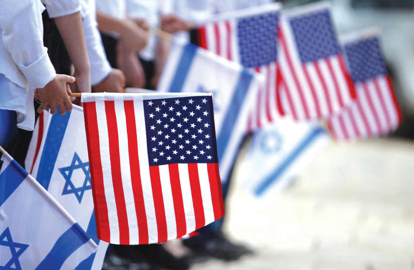 JERUSALEM SCHOOLCHILDREN hold Israeli and American flags during a rehearsal for former US President Barack Obama’s visit to Israel in 2013. (credit: BAZ RATNER/REUTERS) JERUSALEM SCHOOLCHILDREN hold Israeli and American flags during a rehearsal for former US President Barack Obama’s visit to Israel in 2013. (credit: BAZ RATNER/REUTERS)