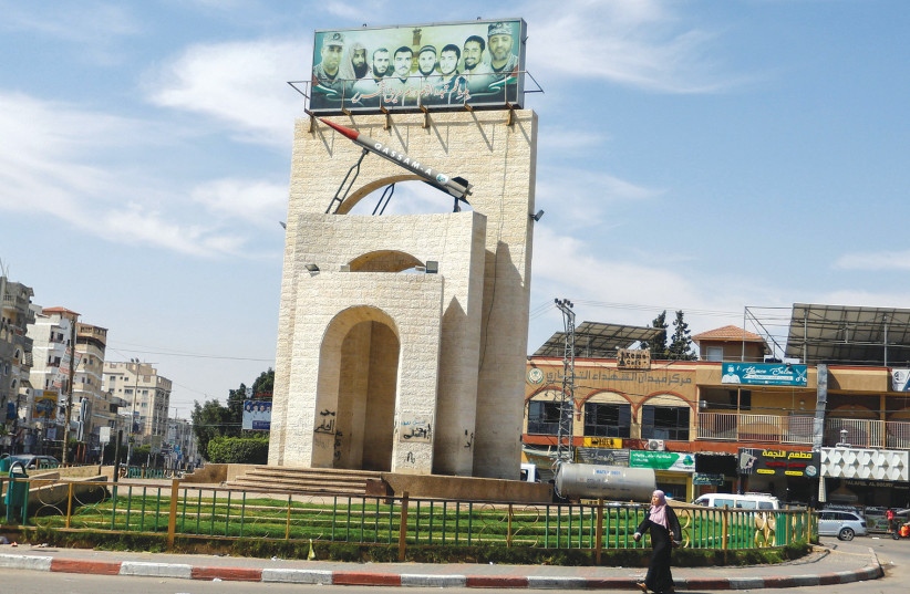 A Palestinian woman walks in front of a roundabout with a model of a Qassam rocket, in Rafah, southern Gaza Strip on June 7, 2023. (credit: IBRAHEEM ABU MUSTAFA/REUTERS) A Palestinian woman walks in front of a roundabout with a model of a Qassam rocket, in Rafah, southern Gaza Strip on June 7, 2023. (credit: IBRAHEEM ABU MUSTAFA/REUTERS)
