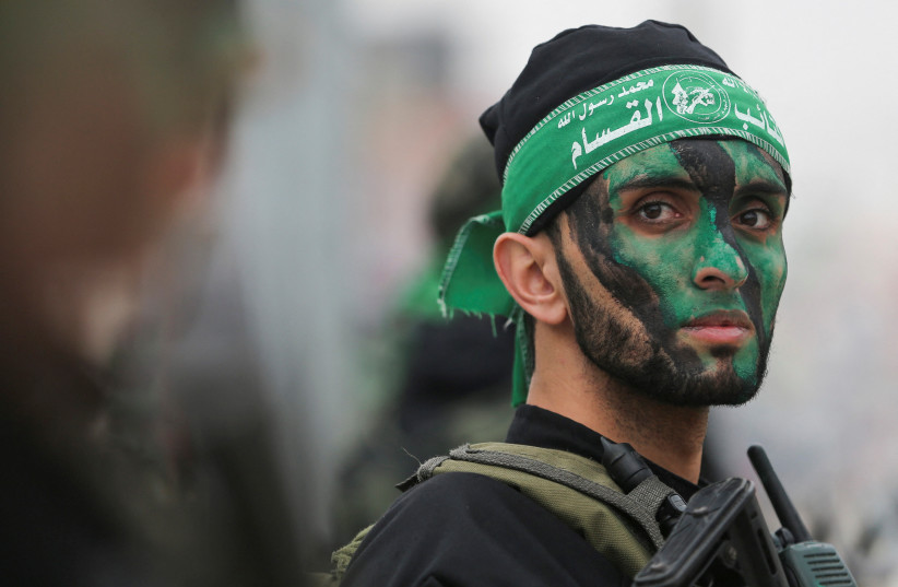 A member of Hamas takes part in a rally during the 35th anniversary of Hamas founding, in Khan Younis in the southern Gaza Strip December 14, 2022. (credit: IBRAHEEM ABU MUSTAFA/REUTERS) A member of Hamas takes part in a rally during the 35th anniversary of Hamas founding, in Khan Younis in the southern Gaza Strip December 14, 2022. (credit: IBRAHEEM ABU MUSTAFA/REUTERS)