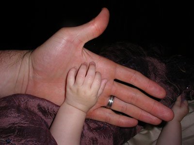 Chez Chesak looks at his daughter’s tiny, plump hand. Photo courtesy of the author.