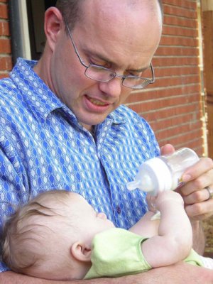 Chez Chesak feeds his new daughter, Lillian, whom he met when she was five months old. Photo courtesy of the author.