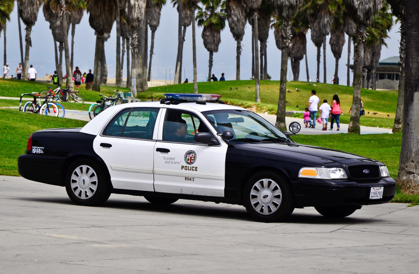 Los Angeles Police Department (LAPD) officers in a car (illustrative). (credit: Wikimedia Commons) Los Angeles Police Department (LAPD) officers in a car (illustrative). (credit: Wikimedia Commons)