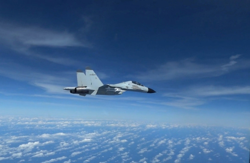 A Chinese Navy J-11 fighter jet is recorded flying close to a US Air Force RC-135 aircraft in international airspace over the South China Sea, according to the US military, in a still image from video taken December 21, 2022. (credit: US Indo-Pacific Command/Handout via REUTERS) A Chinese Navy J-11 fighter jet is recorded flying close to a US Air Force RC-135 aircraft in international airspace over the South China Sea, according to the US military, in a still image from video taken December 21, 2022. (credit: US Indo-Pacific Command/Handout via REUTERS)