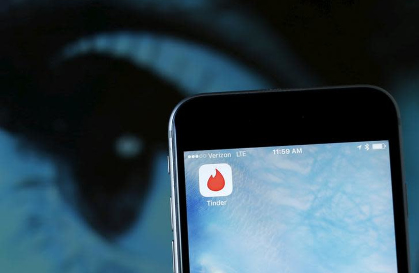 The dating app Tinder is shown on an Apple iPhone in this photo illustration taken February 10, 2016 (credit: REUTERS/MIKE BLAKE) The dating app Tinder is shown on an Apple iPhone in this photo illustration taken February 10, 2016 (credit: REUTERS/MIKE BLAKE)