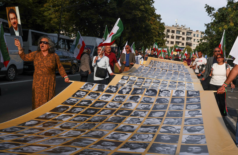 People hold a placard with pictures of, as Iranian call them, martyrs, during a rally of Iranian diaspora in Europe, on the eve of the first anniversary of the death of Mahsa Amini, which prompted protests across their country, in Brussels, Belgium September 15, 2023. (credit: REUTERS) People hold a placard with pictures of, as Iranian call them, martyrs, during a rally of Iranian diaspora in Europe, on the eve of the first anniversary of the death of Mahsa Amini, which prompted protests across their country, in Brussels, Belgium September 15, 2023. (credit: REUTERS)
